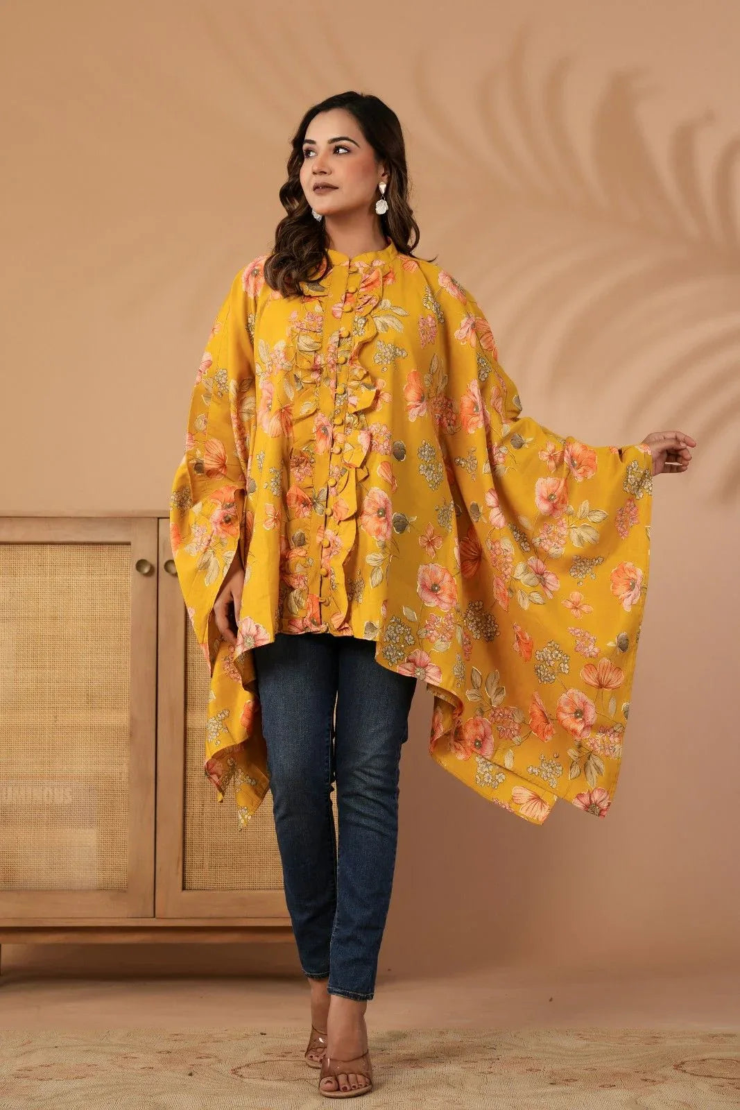 Woman wearing a yellow floral dress against a beige background-YAVASTRAH