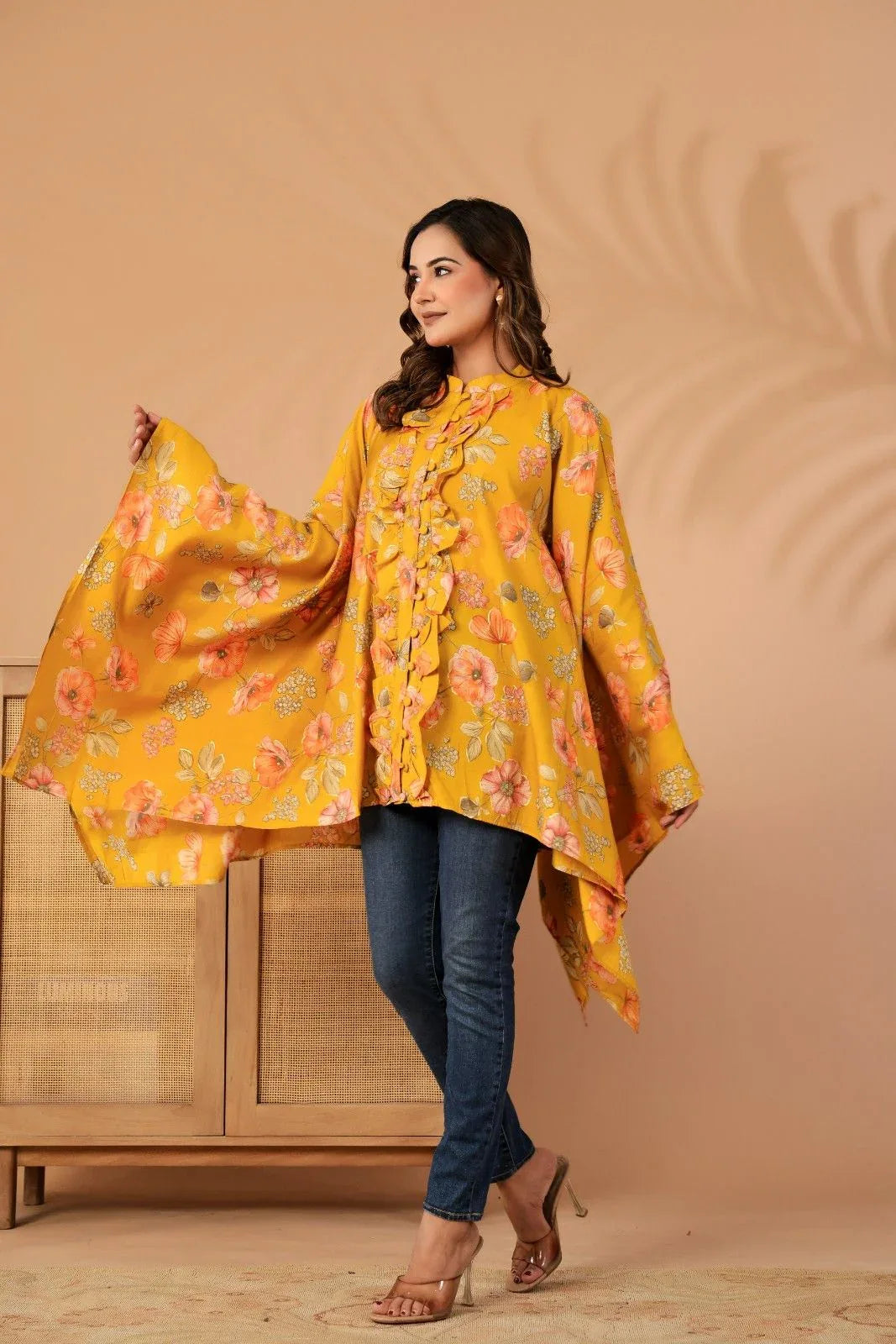 Woman wearing a yellow floral dress against a beige background-YAVASTRAH