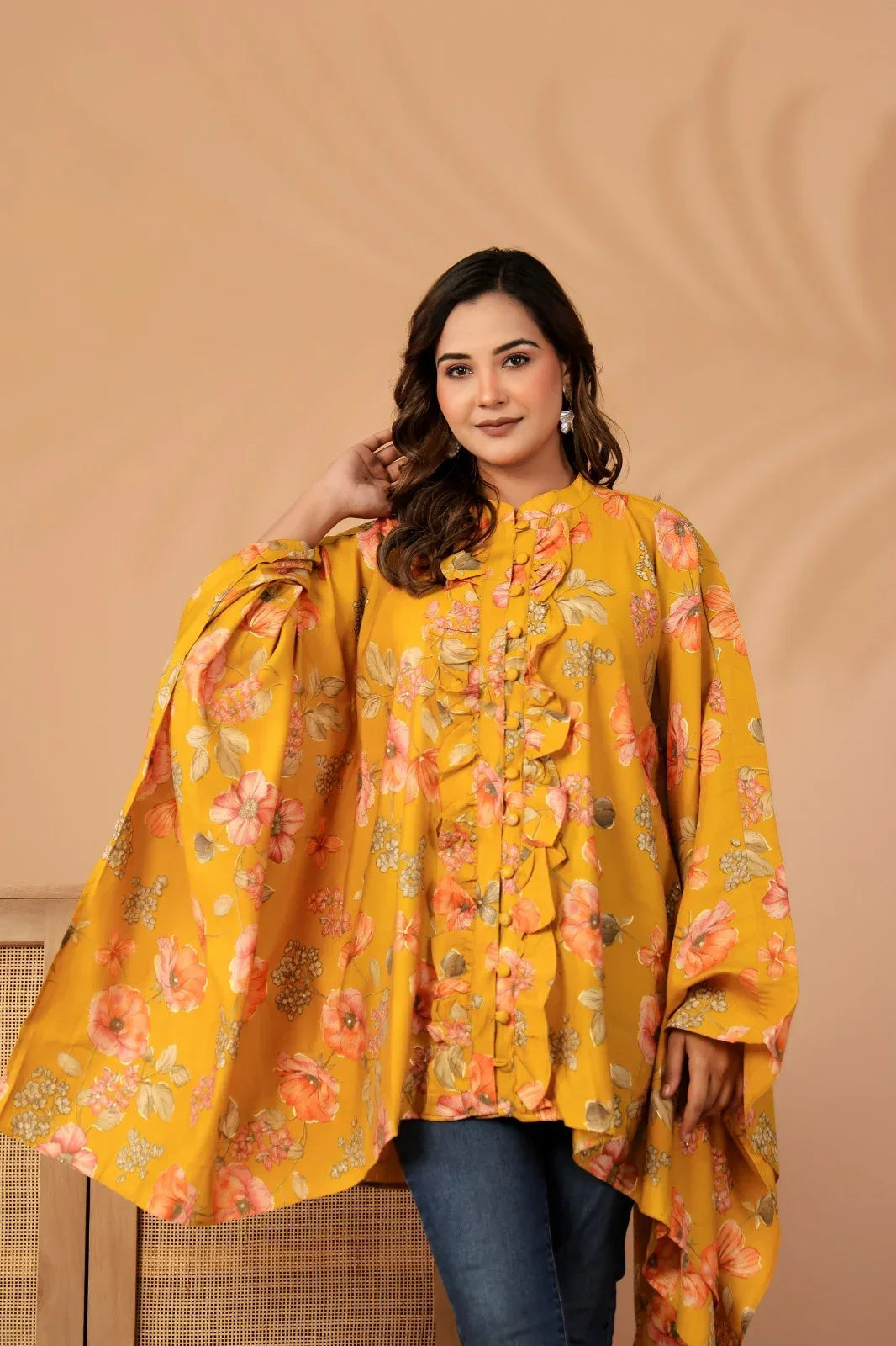 Woman wearing a yellow floral dress against a beige background-YAVASTRAH