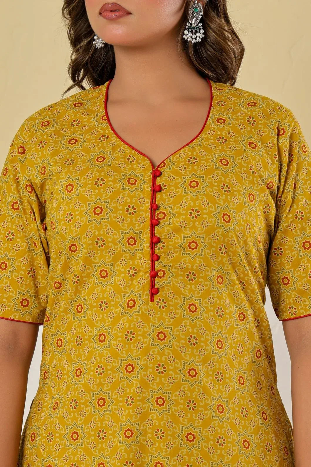 Woman in mustard yellow printed kurta set, close-up of neckline and print - YAVASTRAH