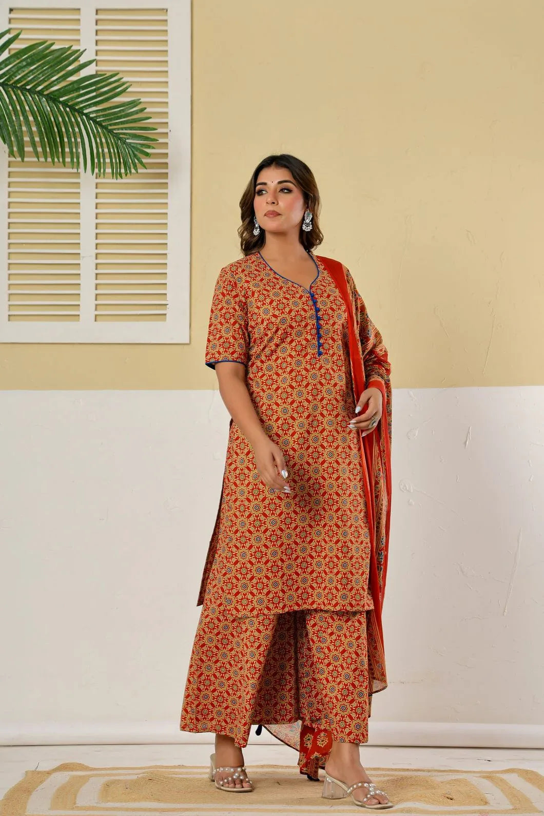 Woman wearing red kurta palazzo set styled with traditional accessories - YAVASTRAH
