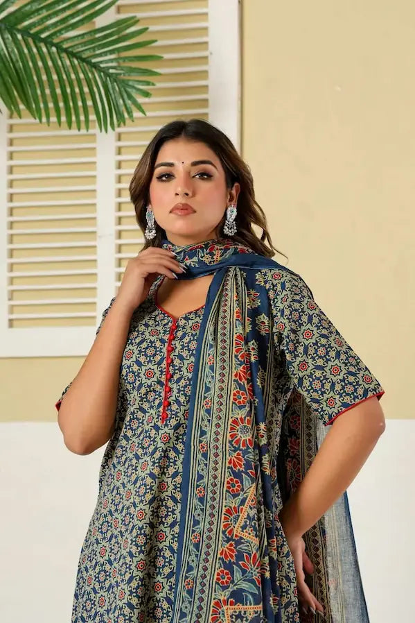 Woman wearing a floral dress with a matching dupatta against a neutral background