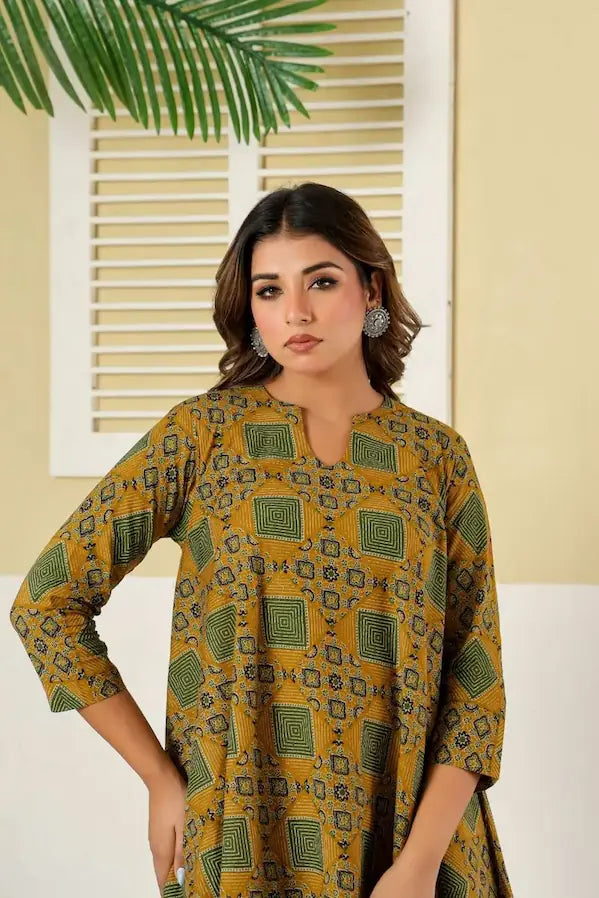 Woman wearing a mustard yellow patterned kurta against a neutral background