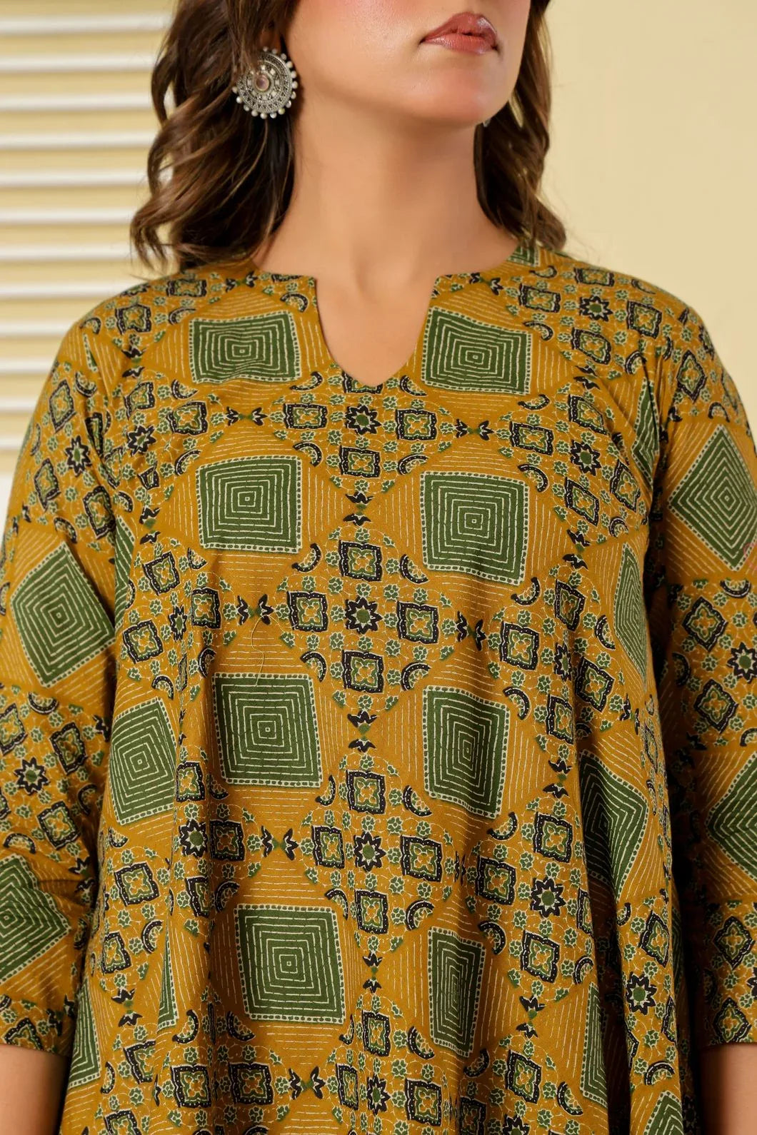 Mustard green floral printed A-line dress, three-quarter view - YAVASTRAH