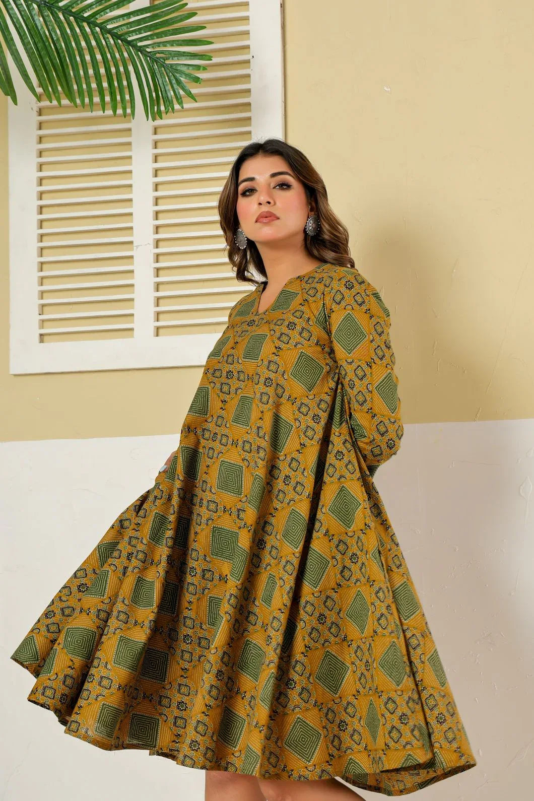 Woman wearing mustard green floral dress styled with traditional accessories - YAVASTRAH