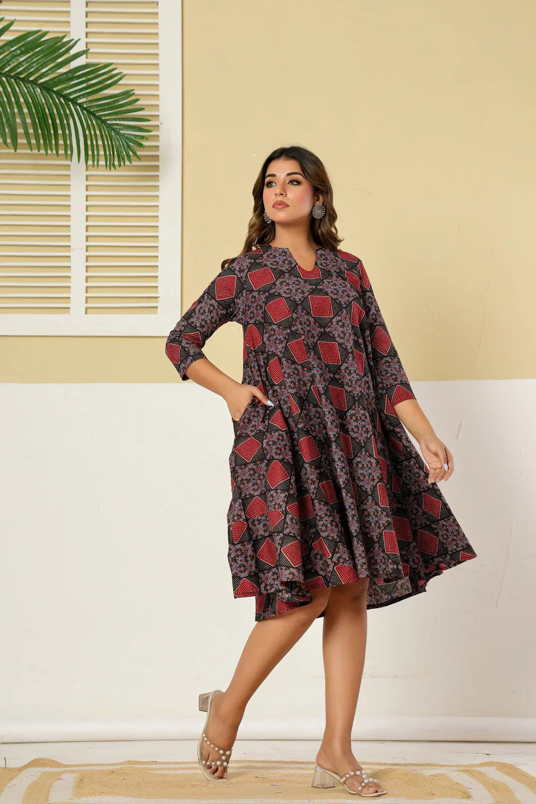 Woman in maroon and black geometric dress, full length view - YAVASTRAH
