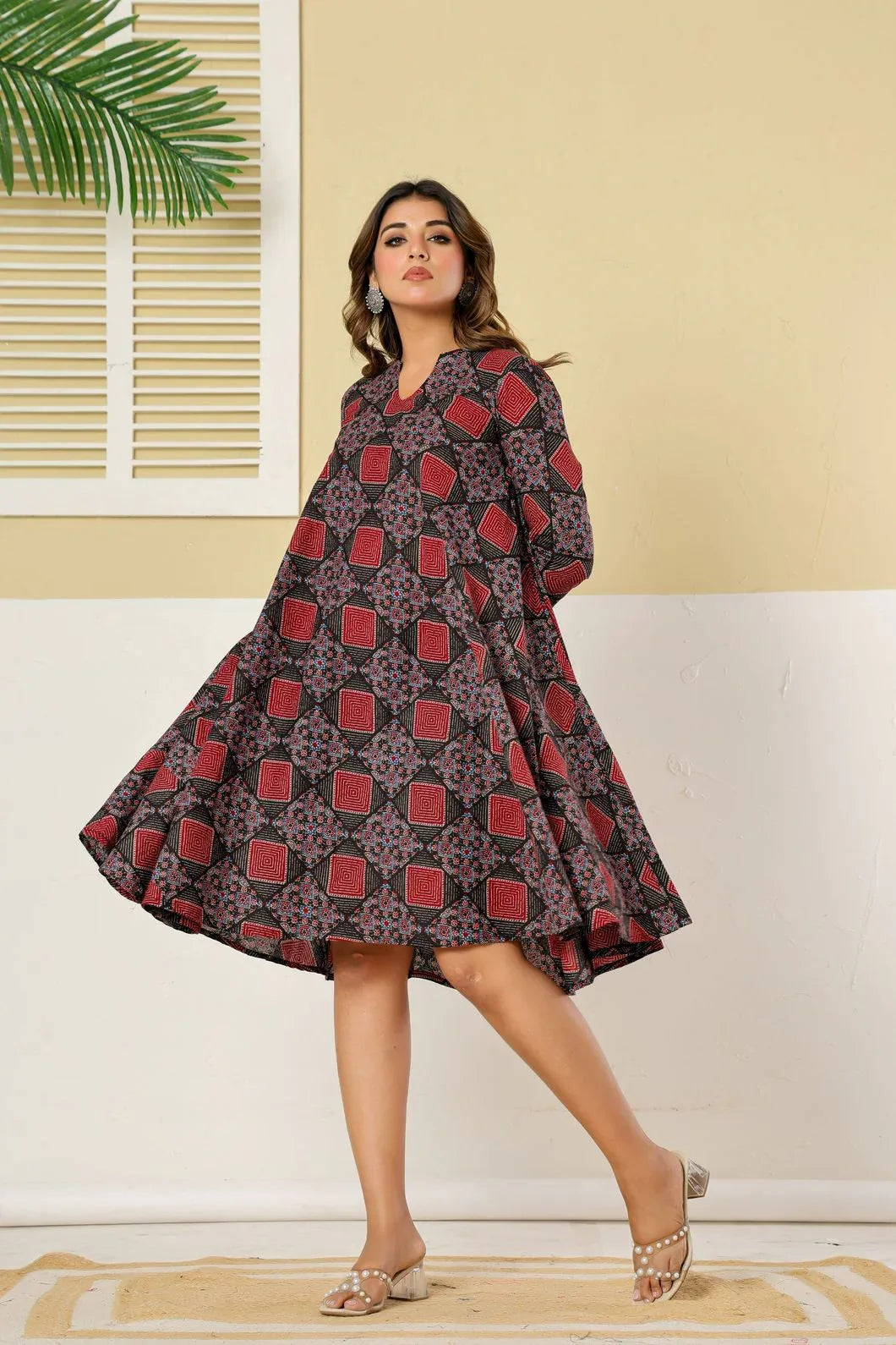 Woman wearing maroon geometric dress styled with traditional accessories - YAVASTRAH
