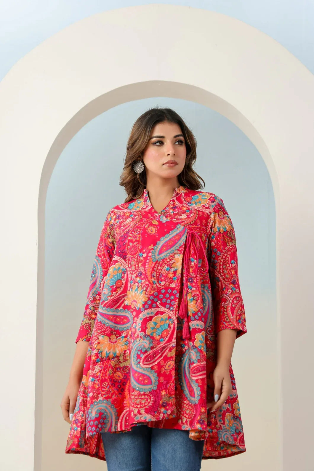 Woman wearing rani pink angrakha kurti styled with traditional accessories - YAVASTRAH
