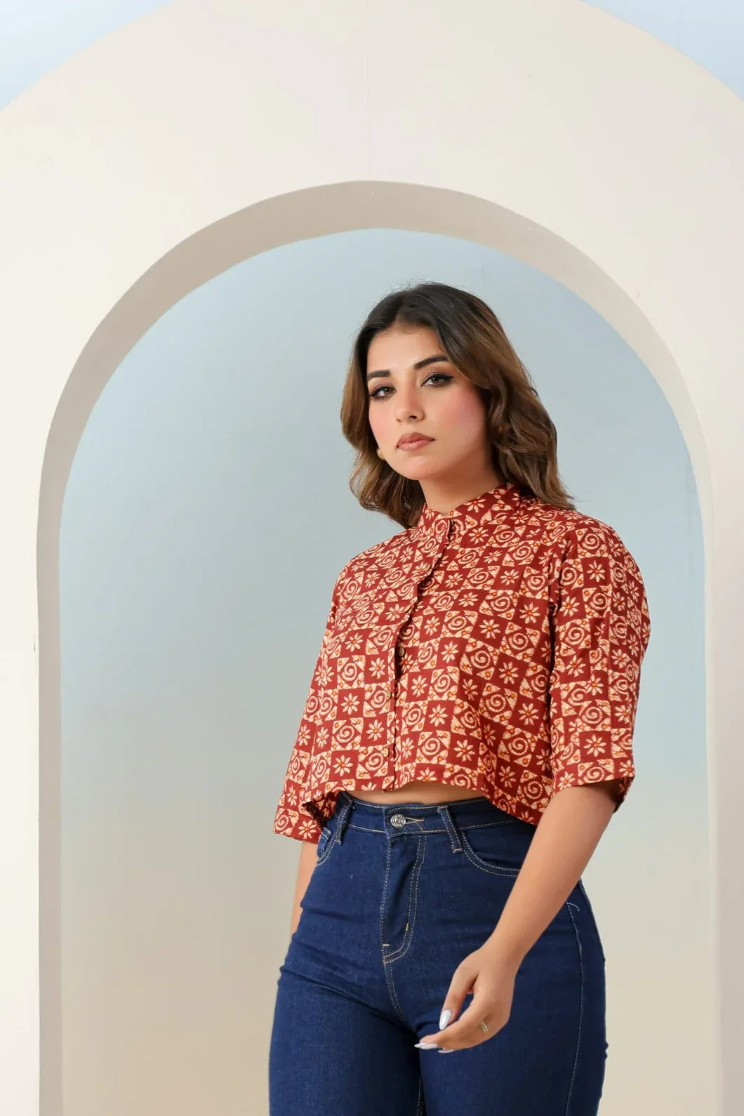 Woman in rust red ethnic motif crop top paired with palazzo pants, full view - YAVASTRAH

