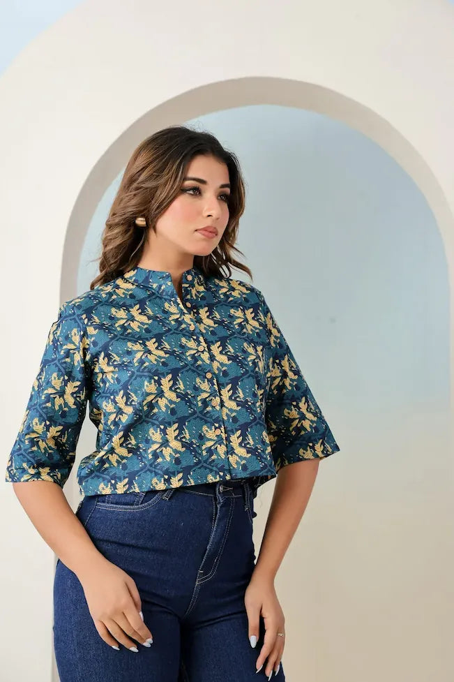 Woman wearing a blue floral blouse with a white background