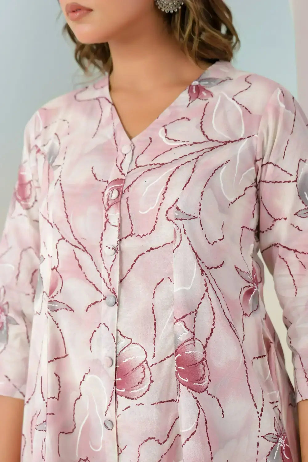 Close-up of a floral patterned shirt with pink and white colors.