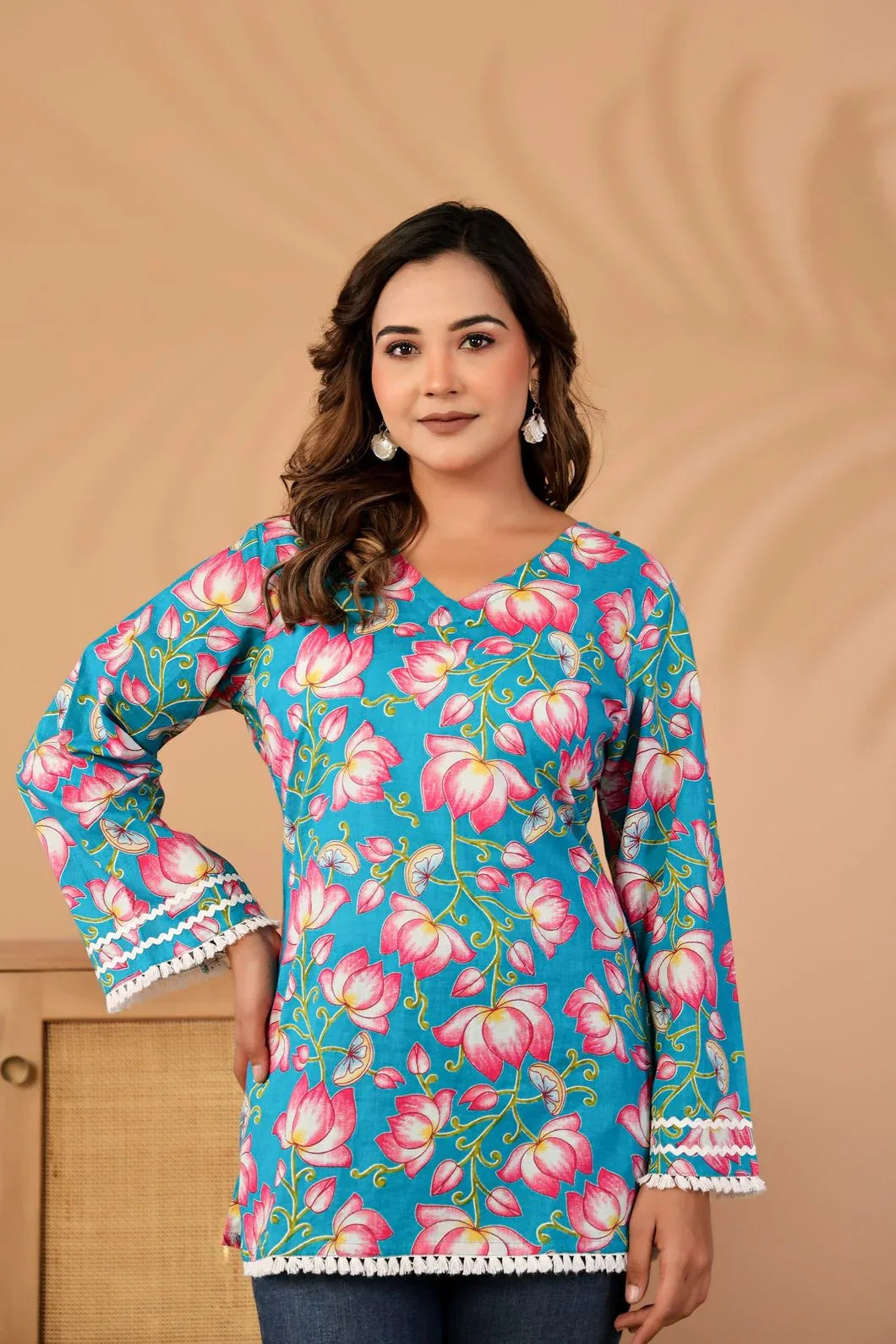 Woman wearing a teal blue floral printed cotton kurti, front view - YAVASTRAH
