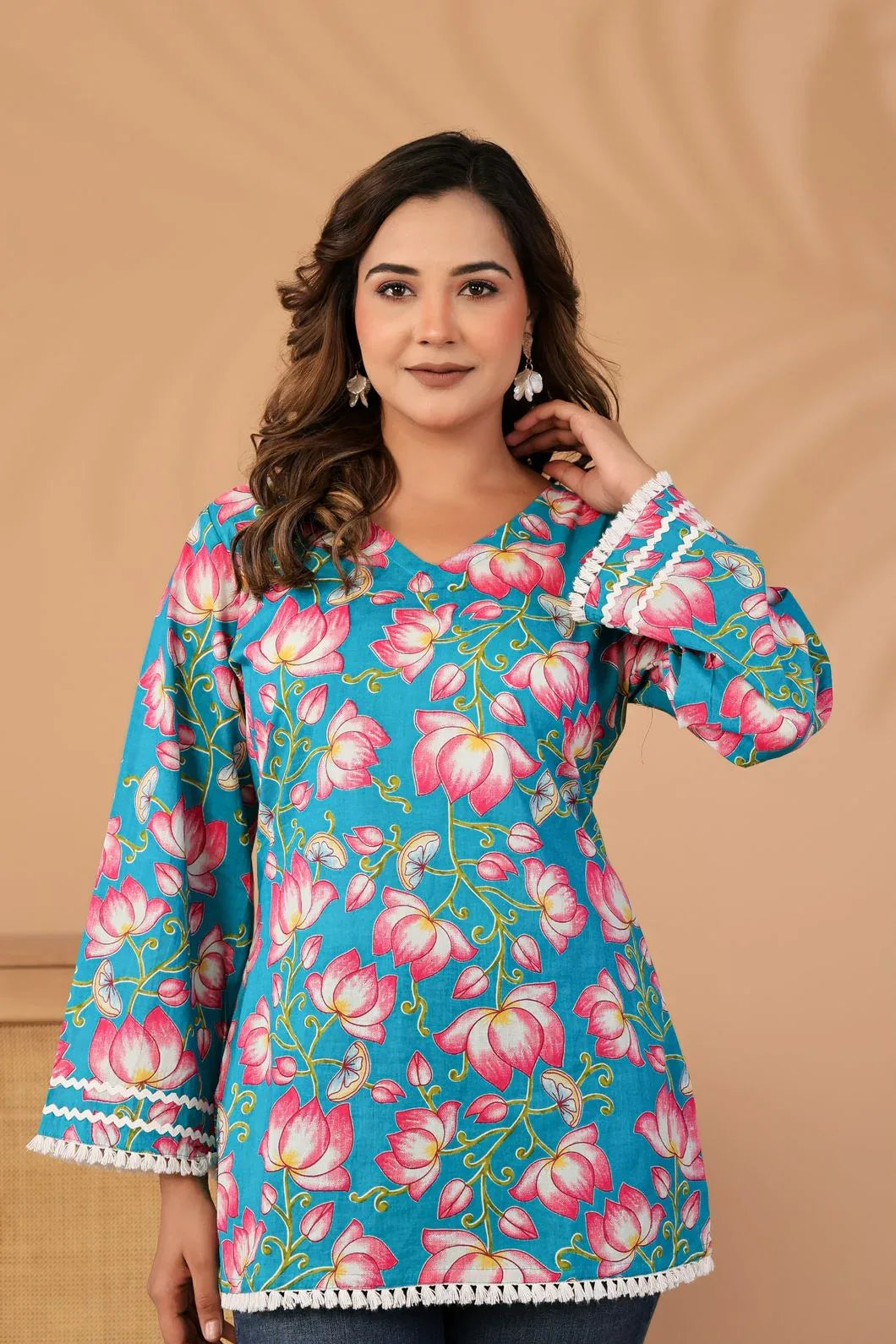 Woman wearing teal blue floral kurti styled with traditional accessories - YAVASTRAH
