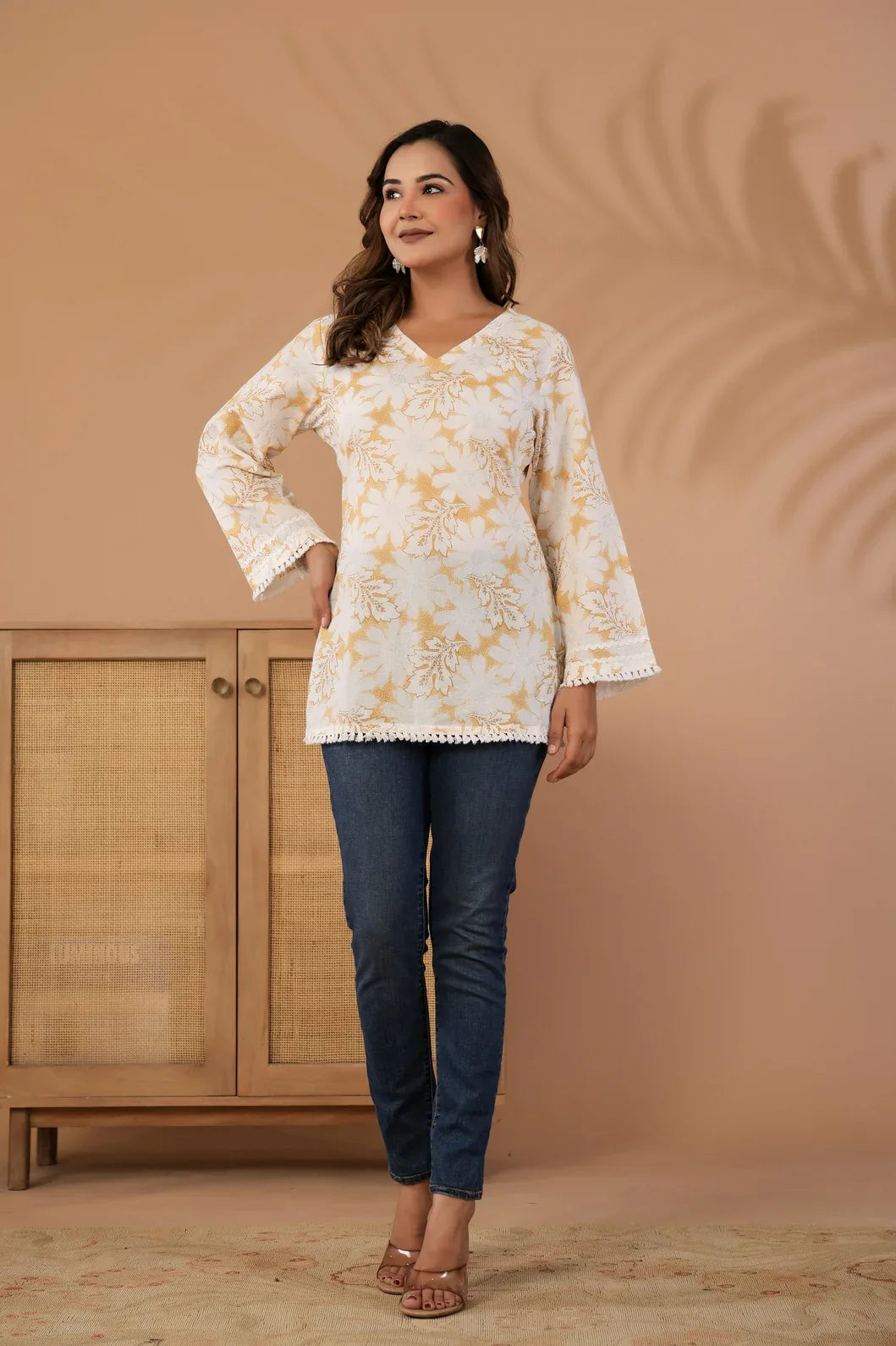 Woman wearing an ivory and mustard floral printed cotton kurti, front view - YAVASTRAH
